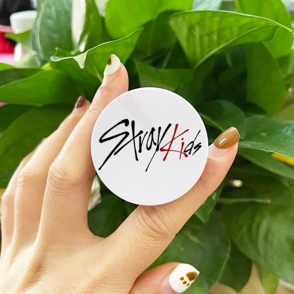Stray Kids official merchandise, compact mirror, or accessory with band logo on it for Kpop fans.