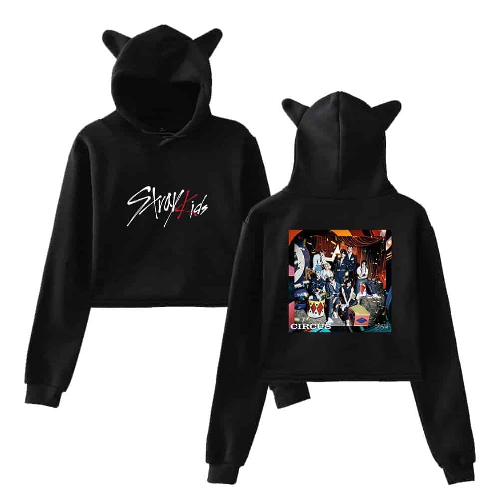 Cute black hoodie with cat ears and a colorful circus-themed design on the back, perfect for K-pop fans and merch collectors.
